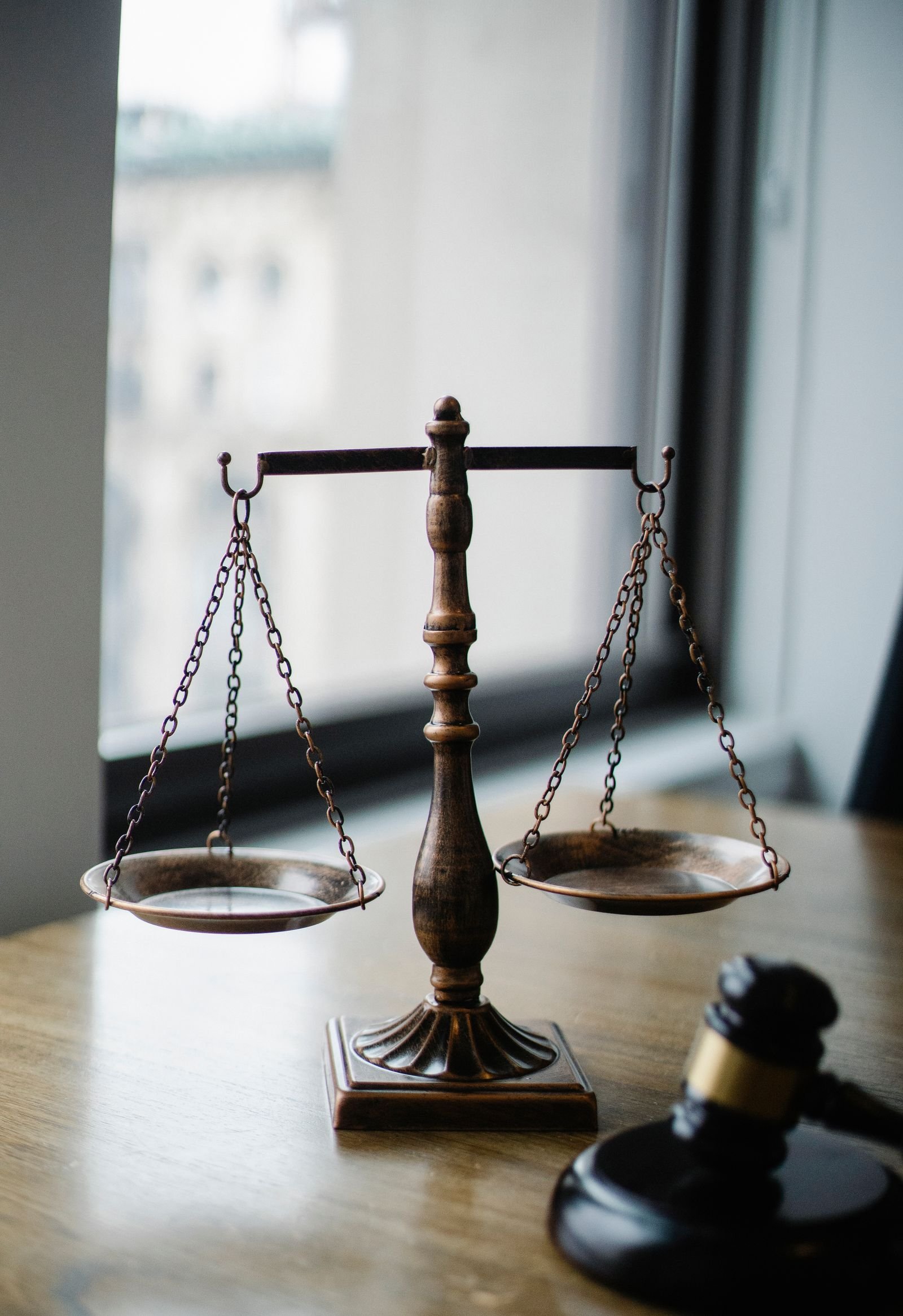 Scales of justice and a gavel on a lawyer's desk