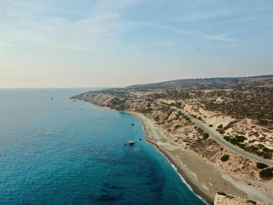 Aerial view of a long beach and dry hills along the Kouklia coast